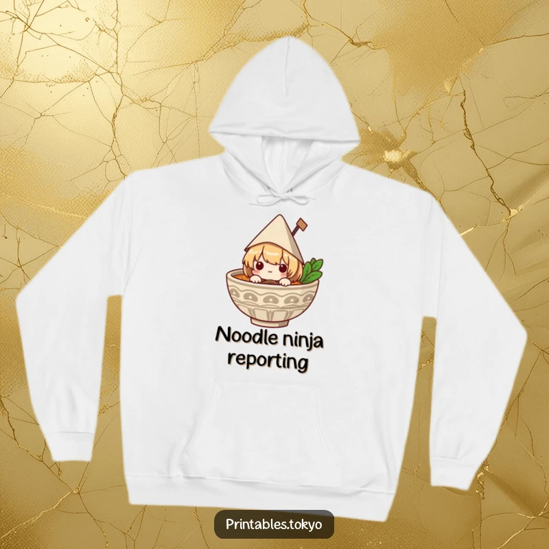 Funny hoodie with a shy character wearing a paper hat, peeking mischievously from a steaming bowl of ramen, radiating warmth and humor.