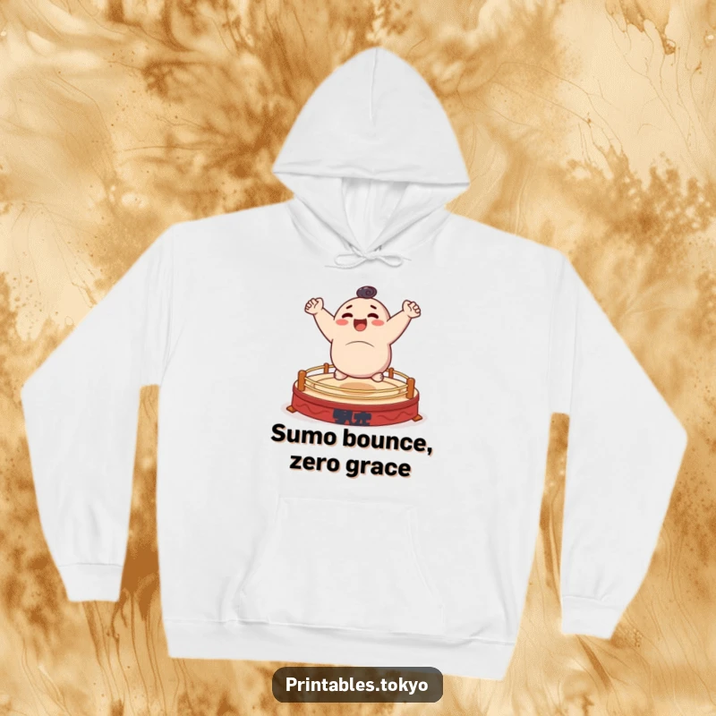 Funny hoodie featuring a character cheerfully bouncing on a small, stylized sumo ring, cozy and energetic.